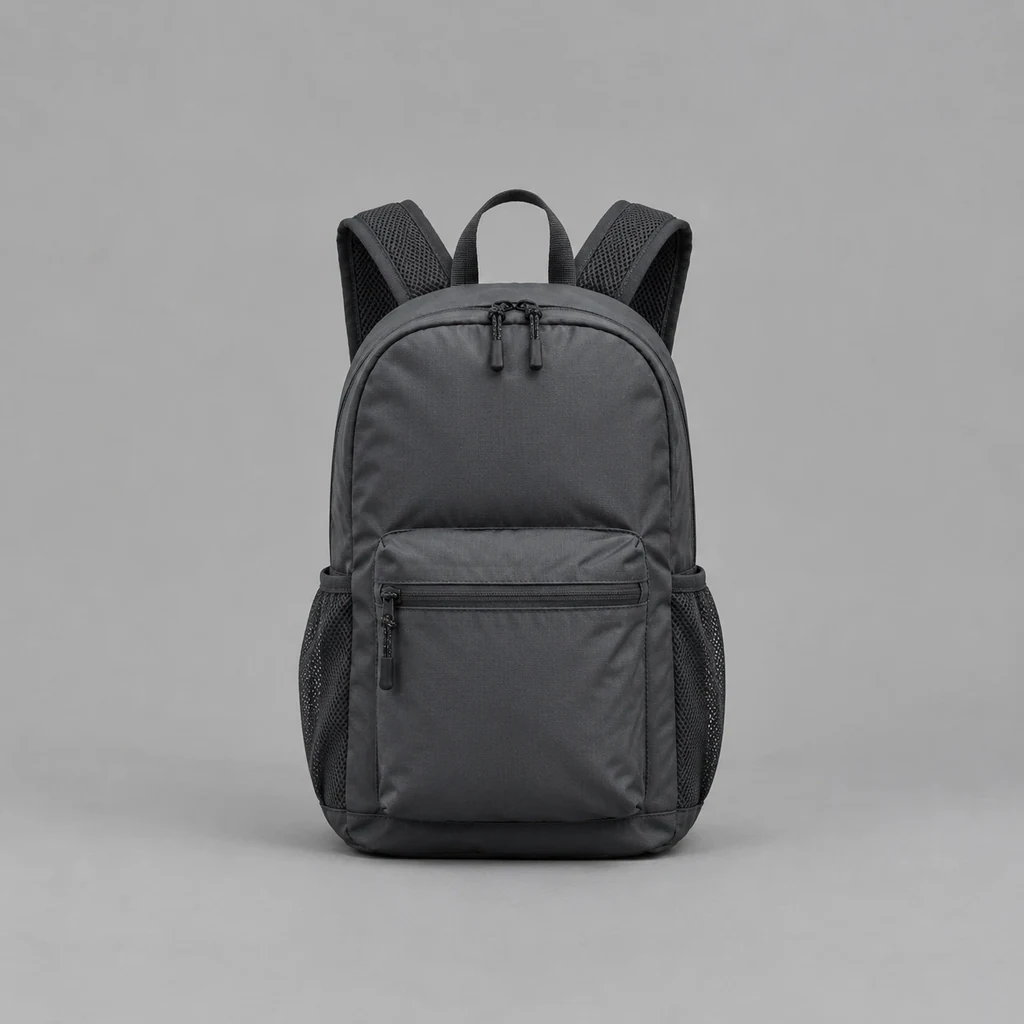 Small charcoal daypack with mesh shoulder straps and a front zip pocket